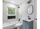 Bathroom features marble tile, and modern fixtures, with a window that provides natural light at 276 Lydia Se Dr, Atlanta, GA 30315