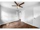 Bright bedroom featuring hardwood floors, a ceiling fan, and white doors at 276 Lydia Se Dr, Atlanta, GA 30315