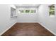 Dining room with hardwood floors, large window, and a pass through opening to the kitchen at 276 Lydia Se Dr, Atlanta, GA 30315