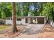Charming exterior view of the home, showcasing the white brick, covered parking, and large front yard at 276 Lydia Se Dr, Atlanta, GA 30315