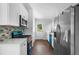 Modern kitchen featuring stainless steel appliances, white cabinets, and stylish backsplash at 276 Lydia Se Dr, Atlanta, GA 30315