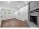 Living room with gray brick fireplace, dark hardwood floors, recessed lighting, and multiple windows at 276 Lydia Se Dr, Atlanta, GA 30315
