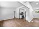 Spacious living room with hardwood floors, leading into a modern kitchen with white cabinets at 276 Lydia Se Dr, Atlanta, GA 30315