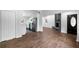 Open-concept living room featuring hardwood floors, a brick fireplace, and a view of the modern kitchen at 276 Lydia Se Dr, Atlanta, GA 30315