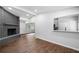 View of living room with hardwood floors, gray brick fireplace, recessed lighting, and passthrough to kitchen at 276 Lydia Se Dr, Atlanta, GA 30315