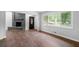 Spacious living room with dark hardwood floors, a fireplace, and a dark door with a window at 276 Lydia Se Dr, Atlanta, GA 30315