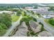 Aerial view of brick townhomes near a tree-lined road, showcasing the community's proximity to amenities and city at 4853 Stonehall Pl, Atlanta, GA 30339