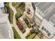 An aerial view of a brick townhome showcasing landscaped walkways, steps to entrances, and a private outdoor space at 4853 Stonehall Pl, Atlanta, GA 30339