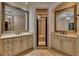 Elegant bathroom with dual vanities, large mirrors, and a glass enclosed shower at 4853 Stonehall Pl, Atlanta, GA 30339