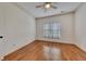 Bright bedroom featuring hardwood floors, ceiling fan, and window with natural light at 4853 Stonehall Pl, Atlanta, GA 30339