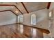 Vaulted bedroom featuring hardwood floors, a stone fireplace, and custom windows at 4853 Stonehall Pl, Atlanta, GA 30339