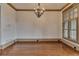Dining room with hardwood floors, chandelier, and a large window with plantation shutters at 4853 Stonehall Pl, Atlanta, GA 30339