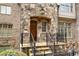 Charming stone exterior with a wooden front door and decorative iron railings at 4853 Stonehall Pl, Atlanta, GA 30339