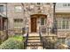 Charming stone exterior with a wooden front door and decorative iron railings at 4853 Stonehall Pl, Atlanta, GA 30339