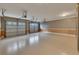 Attached garage with epoxy floors offers ample space for multiple vehicles and storage, enhanced by the multiple garage doors at 4853 Stonehall Pl, Atlanta, GA 30339