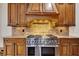 Gourmet kitchen with stainless steel oven and cooktop, wooden cabinets and granite countertops at 4853 Stonehall Pl, Atlanta, GA 30339