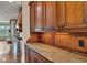 View of kitchen featuring granite countertops, tile backsplash, and wood cabinetry at 4853 Stonehall Pl, Atlanta, GA 30339