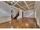 Open-concept living room with hardwood floors, coffered ceiling, and staircase at 4853 Stonehall Pl, Atlanta, GA 30339