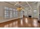 Expansive living room featuring hardwood floors, coffered ceilings, and a charming fireplace at 4853 Stonehall Pl, Atlanta, GA 30339