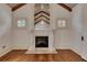 Bright living room features a unique fireplace, hardwood floors, and exposed beam ceiling at 4853 Stonehall Pl, Atlanta, GA 30339