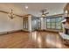 Spacious living room with hardwood floors, stone fireplace, elegant lighting, and views to the outside at 4853 Stonehall Pl, Atlanta, GA 30339