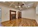 Living room featuring hardwood floors, fireplace, a detailed ceiling, and a window with shutters at 4853 Stonehall Pl, Atlanta, GA 30339