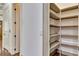 Walk-in pantry with custom shelving for optimal storage in this home at 4853 Stonehall Pl, Atlanta, GA 30339