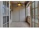 Cozy patio with a ceiling fan, brick accent wall, and outdoor access through French doors at 4853 Stonehall Pl, Atlanta, GA 30339