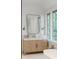 Bright bathroom featuring a vanity with a marble countertop, elegant lighting, and big windows at 1026 Reeder N Cir, Atlanta, GA 30306