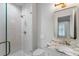 Modern bathroom featuring a glass shower, patterned tile, and an elegant sink with marble countertop at 1026 Reeder N Cir, Atlanta, GA 30306