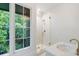 Modern bathroom featuring a glass shower stall and marble sink with a window at 1026 Reeder N Cir, Atlanta, GA 30306