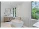 Light-filled bathroom with a modern tub, marble accents, and a wooden vanity at 1026 Reeder N Cir, Atlanta, GA 30306