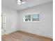 Bedroom featuring a large window, light hardwood flooring, and neutral paint, offering a bright space at 1026 Reeder N Cir, Atlanta, GA 30306