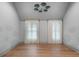 A modern bedroom, featuring a wood floor and a large window with curtains at 1026 Reeder N Cir, Atlanta, GA 30306