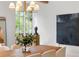 Intimate dining room featuring light fixtures, modern art, and a large window at 1026 Reeder N Cir, Atlanta, GA 30306