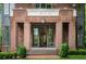Elegant brick home entrance showcasing glass paned double doors and stone address plate at 1026 Reeder N Cir, Atlanta, GA 30306