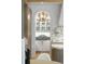 Butler's pantry featuring white cabinets, gold hardware, marble backsplash and modern lighting at 1026 Reeder N Cir, Atlanta, GA 30306
