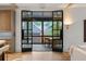 Living room with floor to ceiling windows, fireplace and access to a patio at 1026 Reeder N Cir, Atlanta, GA 30306
