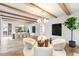 Open-concept living room with dining area, exposed beams, and lots of natural light at 1026 Reeder N Cir, Atlanta, GA 30306