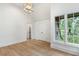 Bright room featuring hardwood floors, white trim, a ceiling light fixture, and double hung windows at 1026 Reeder N Cir, Atlanta, GA 30306