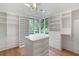 Spacious walk-in closet with custom shelving, drawers, and a center island for ample storage at 1026 Reeder N Cir, Atlanta, GA 30306