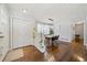 Inviting foyer featuring gleaming hardwood floors, coat closet, and a dining area with modern lighting at 1755 Fairburn Sw Rd, Atlanta, GA 30331