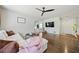 Bright living room featuring hardwood floors, a ceiling fan, and an open layout at 1755 Fairburn Sw Rd, Atlanta, GA 30331