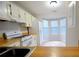Eat-in kitchen with white appliances, wood countertops, and bay window at 755 Heritage Valley Rd, Norcross, GA 30093