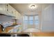 Eat-in kitchen with white appliances, wood countertops, and bay window at 755 Heritage Valley Rd, Norcross, GA 30093