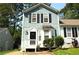 Charming two-story home featuring blue siding, black shutters, and a well-manicured front yard at 775 Heritage Valley Rd, Norcross, GA 30093