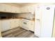 Functional kitchen featuring white cabinets, appliances, and laminate flooring at 775 Heritage Valley Rd, Norcross, GA 30093