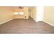 Open-concept living area with laminate wood flooring, leading into the kitchen area at 775 Heritage Valley Rd, Norcross, GA 30093