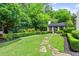 Lush backyard with a stone path leading to an outdoor pavilion at 980 Fenimore Cir, Atlanta, GA 30350