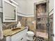 Elegant bathroom with a granite countertop, decorative tile accents, and a beautifully tiled walk-in shower at 980 Fenimore Cir, Atlanta, GA 30350